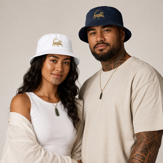 A man and a woman wearing matching bucket hats with a gold wētā logo. The woman's hat is white, and the man's hat is navy blue.